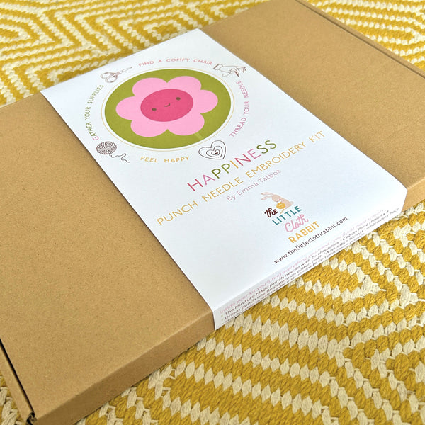 Angled view of Miniature Punch Needle Flower Kit box with Happiness belly band