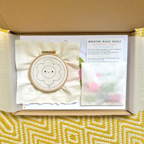 Miniature Punch Needle Flower Kit partially wrapped revealing kit contents inside box
